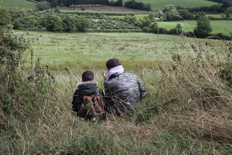 two people
					sitting in a field